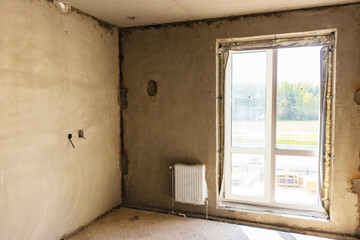 New apartment without finishing. Concrete walls in the apartment before renovation. Housing ready for renovation.
