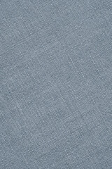 Fototapeta na wymiar Light blue woven surface close-up. Linen textile texture. Fabric handicraft background. Pale textured braided backdrop. Len vertical wallpaper. Macro