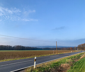 Fototapeta na wymiar country road in german eifel region with fields