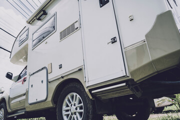 Travel camp trailer car with on the ground with grass