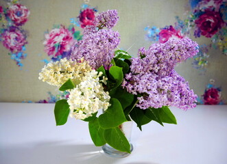 Lilac twigs in a vase. Spring lilac blooms