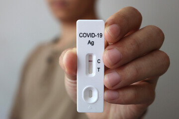 Close up Antigen Test kit : Man holding Rapid Antigen Test kit with show negative result during swab COVID-19 testing