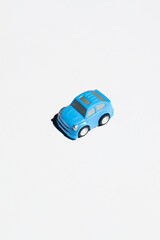 Children toy. small blue car on a light background