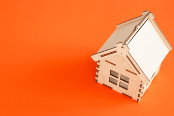 Mini wooden house on red background, Residence and House Loan Concept.