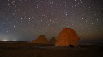 amazing night sky in the white desert in Egypt with countless stars in the sky and beautiful rock...