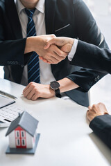 Successful deal Real estate lease or home purchase concept buyer shakes hands with bank employee...