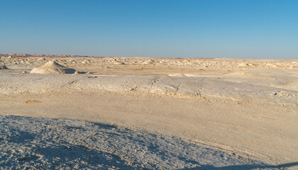 Sunset in the white desert in Egypt, with amazing white rock formations and the sun setting