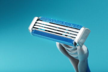Shaving machine with three blades on a blue background close-up free space