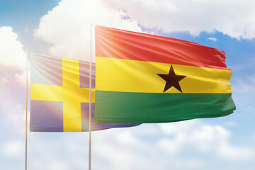 Sunny blue sky and flags of ghana and sweden