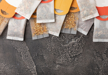 Herbal tea Superfood. Close-up tea bag for brewing in a cup on a black textured background. copy space. Place for text.