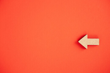 Wooden arrows point on red background. Space for your text