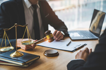 Lawyer or judge holding Hammer prepares to judge the case with justice, and litigation, scales of justice, law hammer, Legal consulting services, Concept of litigation, and legal services.
