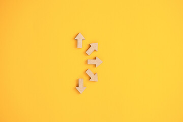 Business investment growth concept , Wooden arrows on yellow background. Space for your text
