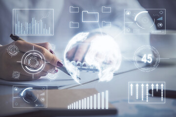 Double exposure of woman's hands making notes with forex graph hologram. Concept technical analysis.