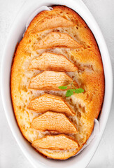 Semolina cake or mannik topped with apple slices served in a baking dish. Soviet cuisine dessert....