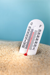 Weather thermometer with high temperature outdoors in the sand