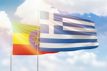 Sunny blue sky and flags of greece and ethiopia