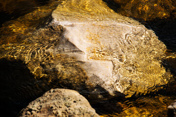 river stones under clear water