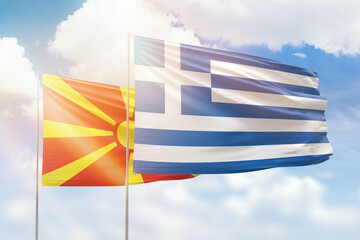 Sunny blue sky and flags of greece and north macedonia