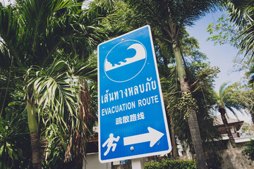 A sign showing a tsunami evacuation route at island in Thailand