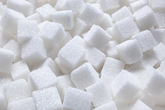 Rafinated sugar. Textured white background from sugar cubes.