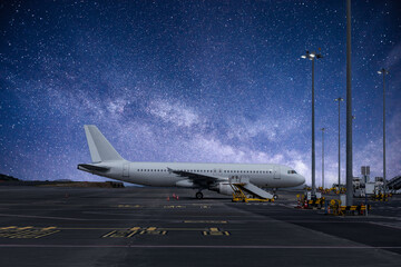 Airplane at airport terminal at night, dreamliner concept