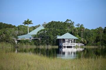 Ernest F Coe Visitor Center at entrance to Everglades National Park, Florida reflected in calm pond...
