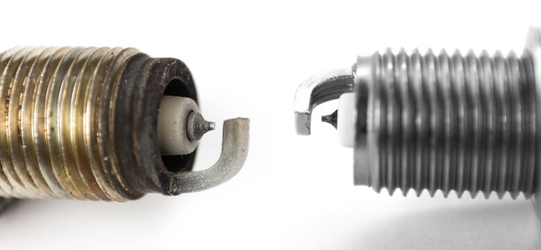 The electrode on the new and used iridium spark plugs. Close up. Isolated on a white background