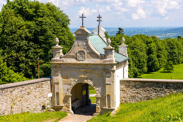 Swiety Krzyz, Poland - June 5, 2022: Lysa Gora, Swiety Krzyz mount hilltop with gate to medieval Benedictive Abbey and sanctuary in Swietokrzyskie Mountains near Nowa Slupia village in Poland