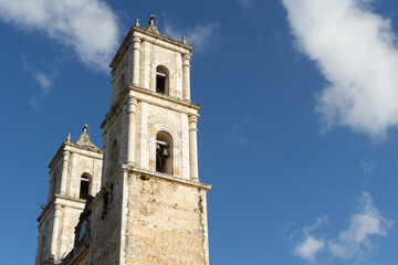 Fototapeta na wymiar Bell towers of the old catholic cathedral against the sky. Colonial Catholic Church, Mexico.