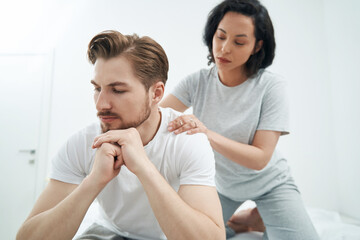 Affectionate lady giving her life partner relaxing massage