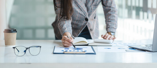Female freelance reading financial graph charts Planning analyzing marketing data. Hands of young woman working in office firm business info.