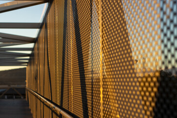 aluminum composite panels or cladding with perforated sheets on modern building facade on sunset,...