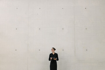Fototapeta na wymiar Business woman using tablet pc in minimalist office interior