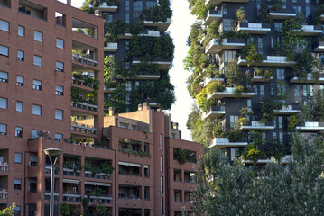 Skyscraper apartment buildings with green oases on the balconies, vertical forest.