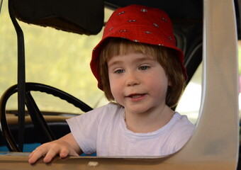 Ramla. Israel. Truck and transport museum. A little boy is driving a vintage Studebaker. Blue retro...
