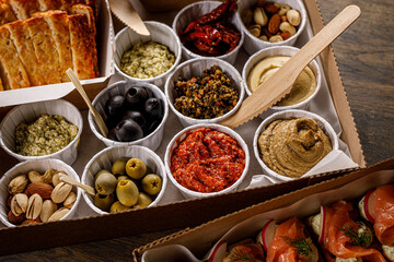 Set of sauces, appetizers, vegetables and hummus.