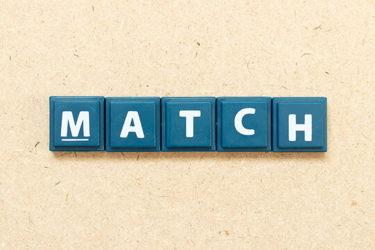 Tile alphabet letter in word match on wood background