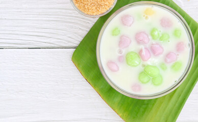 Thai dessert with colorful flour, milk, egg, rainbow colored tapioca Famous Thai dessert, Bualoy on a wooden table, top view.