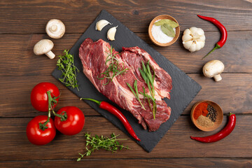 Raw beef steak on wooden table top. Healthy food concept. beef cut and spices for cooking bbq sauce