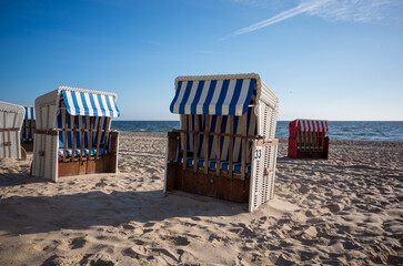 Strandkorb providing shelter from sun and wind. Hooded Wicker beach chairs on a beach at the baltic sea in Bansin, Usedom, Germany