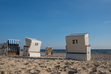 Strandkorb providing shelter from sun and wind. Hooded Wicker beach chairs on a beach at the baltic sea in Bansin, Usedom, Germany