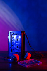 Vintage cassette tape player in neon light. 80s - 90s advertisement style. Disco party nostalgy...