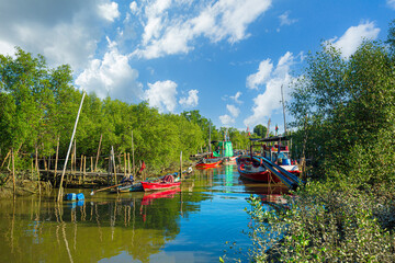Mangrove forests and fishing boats,Ships and a harbour in the river near the Andaman sea at south of Thailand and mangroves forest. This is a simple peaceful traditional life and culture of Thai