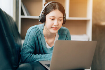 Shot of a asian young business Female working on laptop in her workstation.