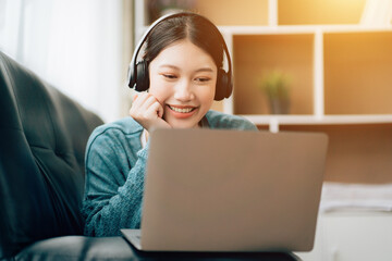 Shot of a asian young business Female working on laptop in her workstation.