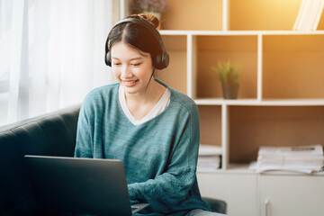 Shot of a asian young business Female working on laptop in her workstation.