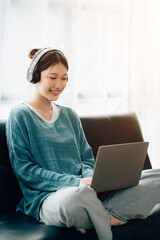 Shot of a asian young business Female working on laptop in her workstation.