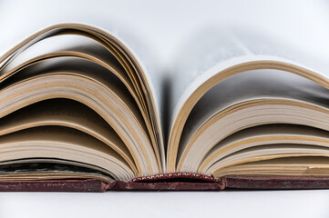 Large open book. Encyclopedia in red hardcover. Close-up. Selective Focus.