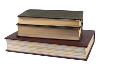 A stack of books isolated against a white background. Large red book and two green ones. Closed books with yellowed pages. Hardcover. Literature, reading, knowledge. Close-up. Selective Focus.